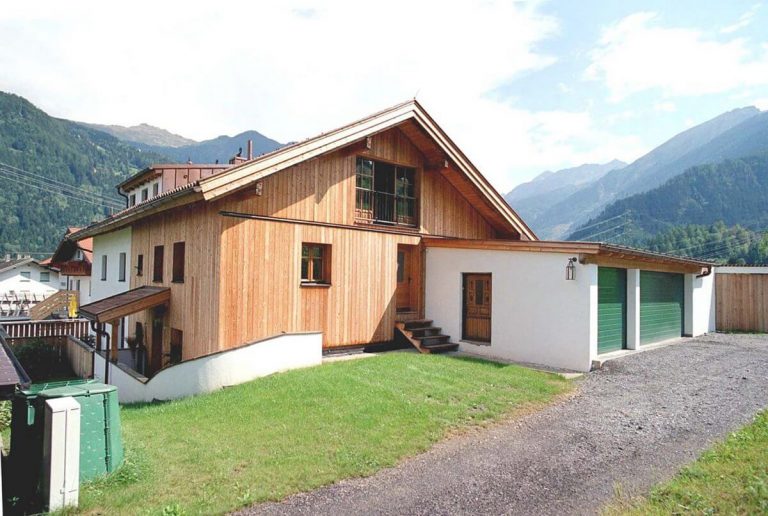 Nordwest Fassade aus Holz mit Garagenvorbau in Wenns